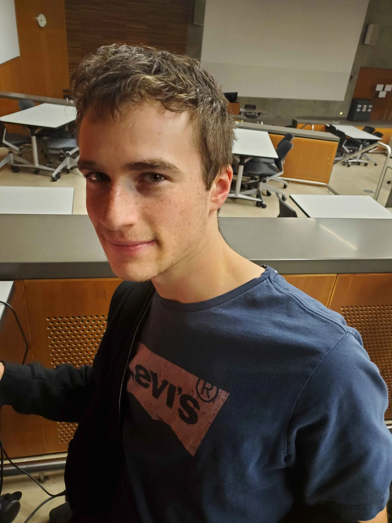 Team member seated in a school workspace